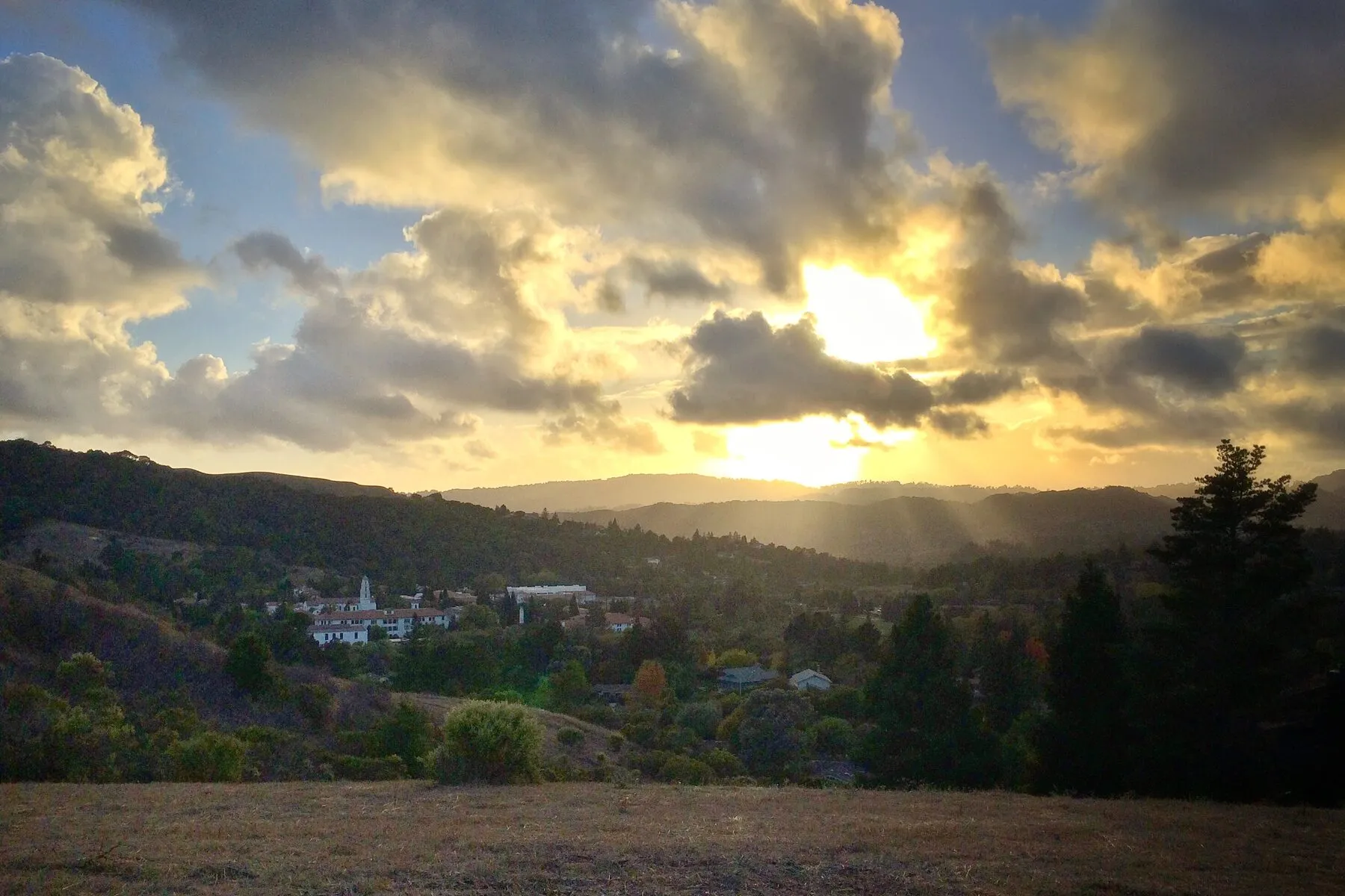 Sunset over the Moraga valley, with the Saint Mary’s College bell tower below the ridgeline and the Contra Costa hills beyond.