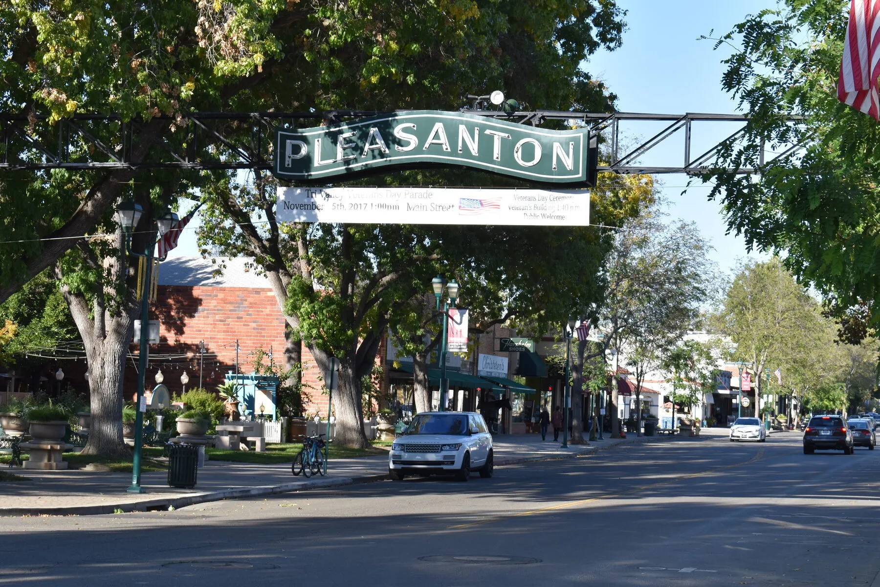 The Pleasanton arch over Main Street, with the downtown storefronts receding behind it.